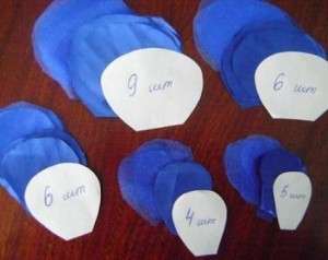 Bei jeder Hausfrau des Hauses findet man Reste von Organza, Tüll, Satin und anderen Stoffen. Um eine üppige und voluminöse Blume zu machen, müssen Sie Blütenblätter unterschiedlicher Größe aus künstlichem Stoff schneiden. Am besten bereiten Sie Muster solcher Blütenblätter im Voraus vor, damit Sie eine schöne Stoffblume erhalten.